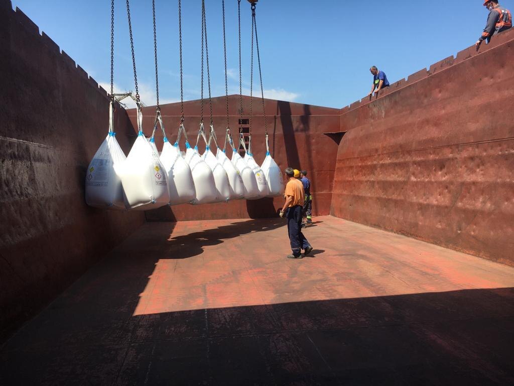 Big bag cargo being loaded into the hold of a general cargo vessel