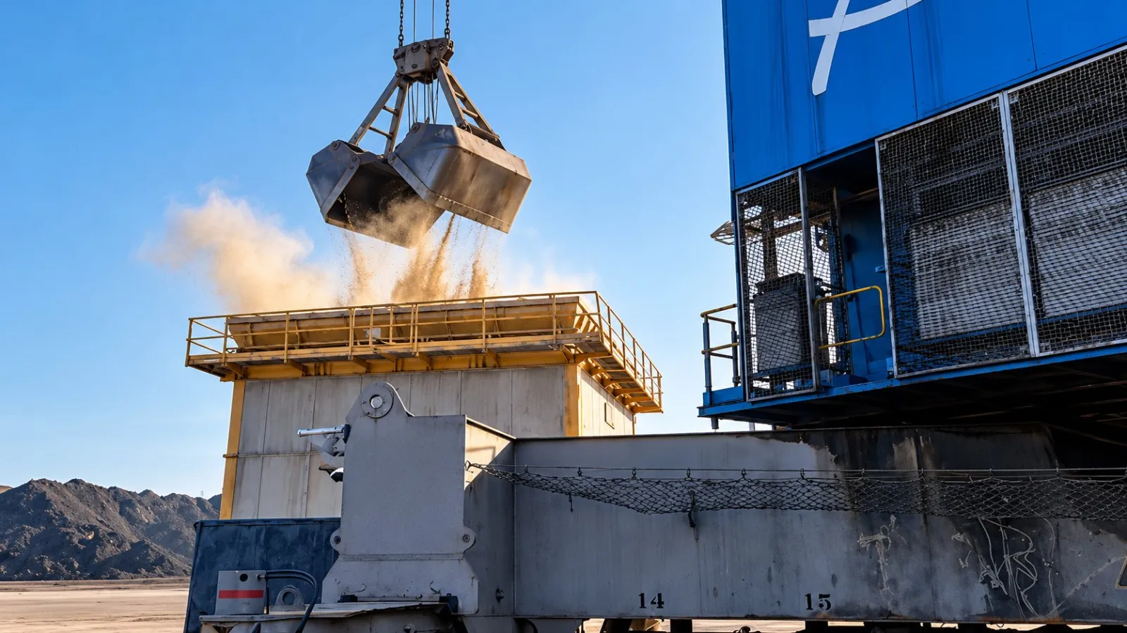 Grab discharging dry bulk cargo into a port hopper